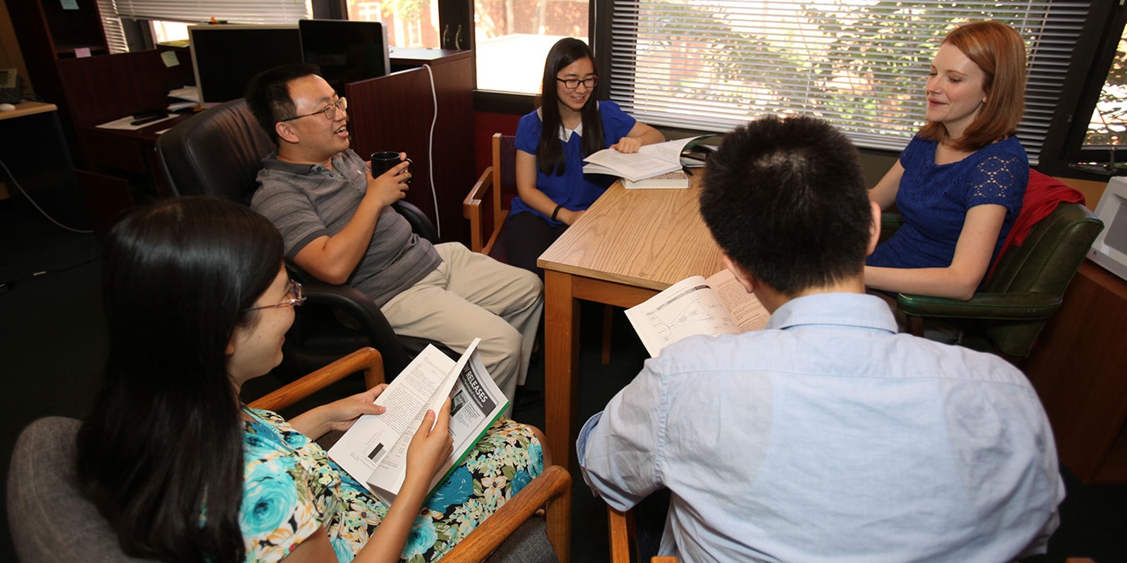 Faculty and PhD in Management students meet in UF Warrington's Human Resource Research Center to discuss recent industry findings