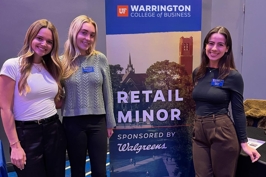 Students gather around a retail banner. 