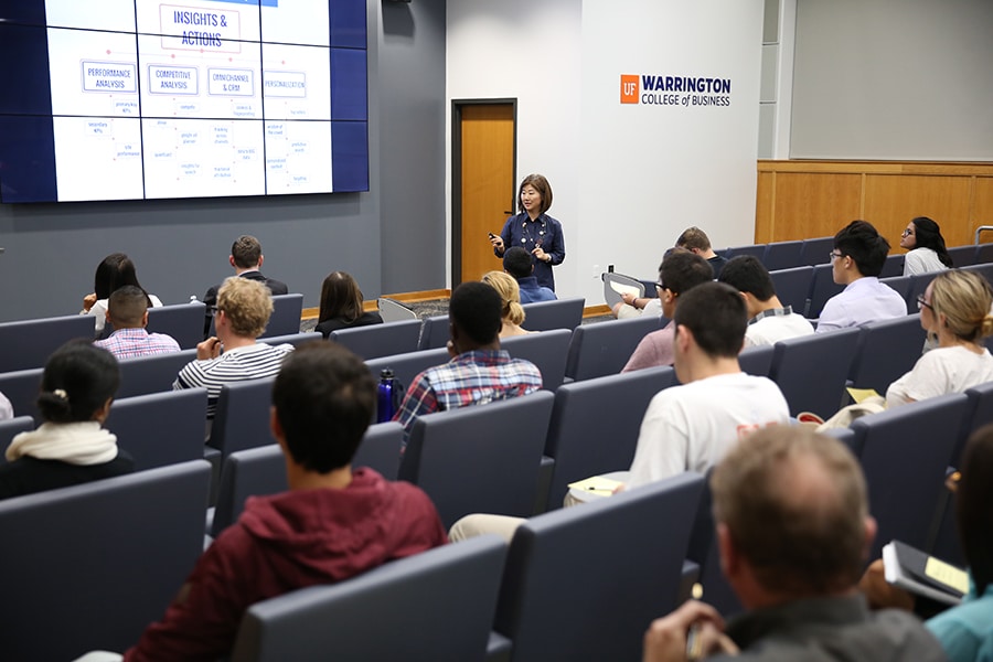 Speaker in front of a retail crowd. 