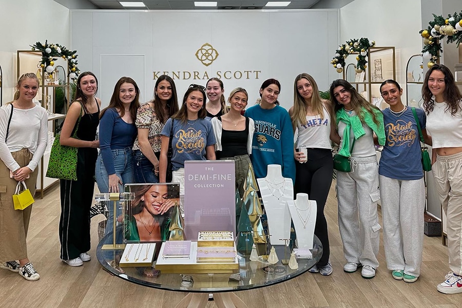 Retail Society students pose in a Kendra Scott store.
