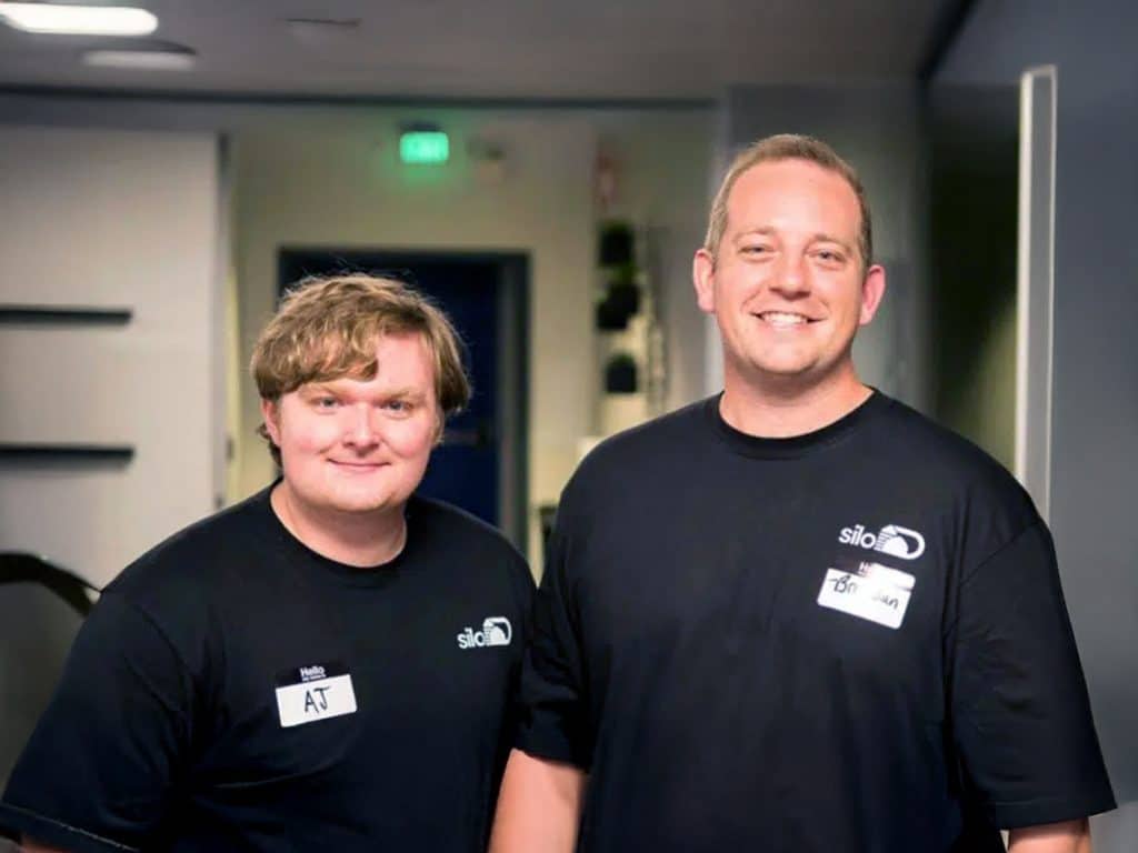 Two men posing in siloD shirts. 