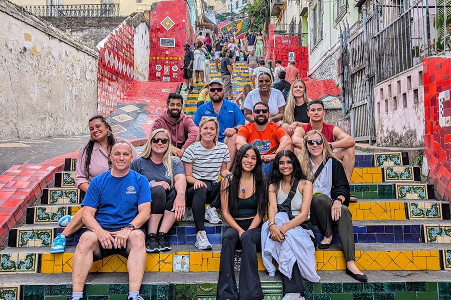Group of students sitting on colorful steps. 