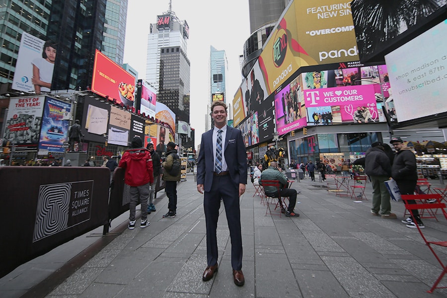 Young man in professional attire standing in New York City.