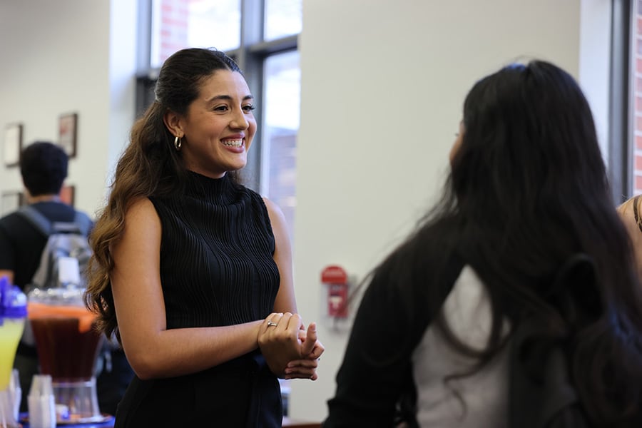 Student smiling at a recruiter at a career event.
