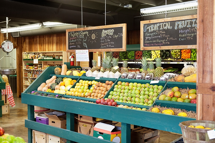 Fresh fruits stall with text on blackboard in supermarket