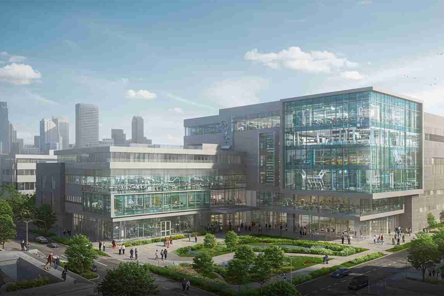 Architectural rendering of the new University of Florida graduate campus in Jacksonville, featuring a modern multi-story glass and concrete building with landscaped green spaces and a city skyline in the background.