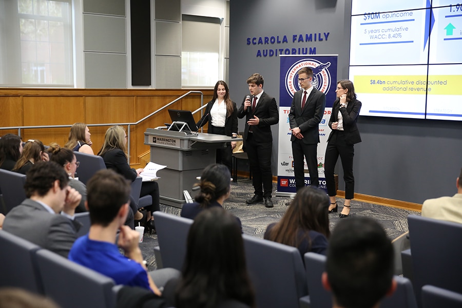 A group of Warrington College of Business students present their business plan to an auditorium of judges and peers at the Heavener International Case Competition