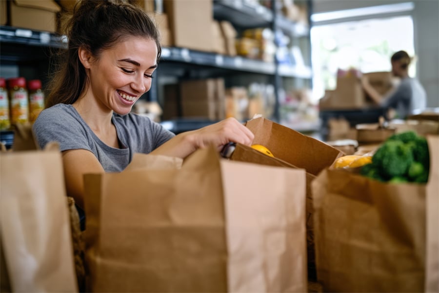 A woman volunteering in a food pantry.