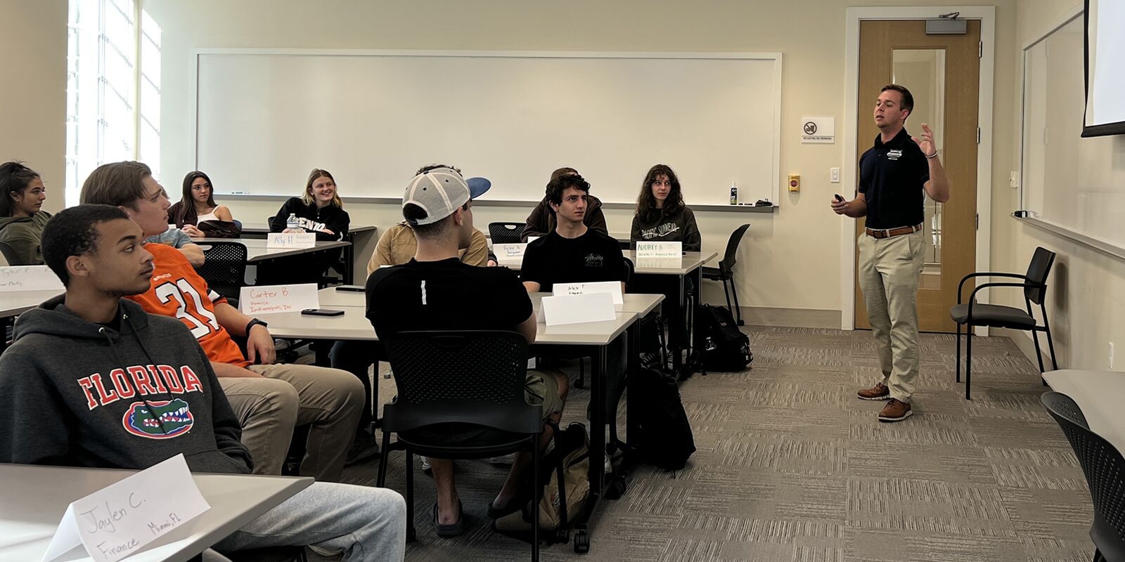 A student speaking to a classroom. 