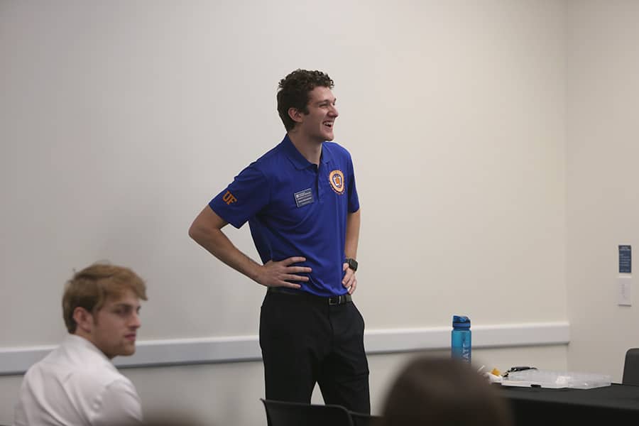 Warrington Diplomat standing in front of seated students.