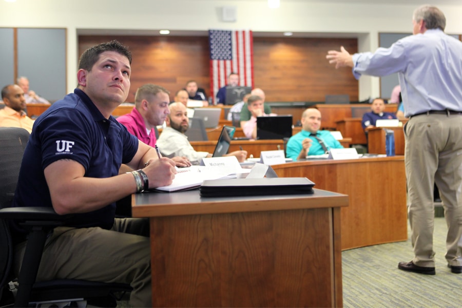 MBA student takes notes during a weekend classroom session in Jacksonville