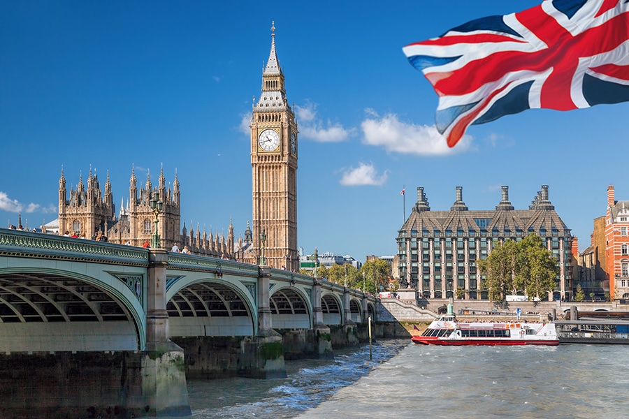 Big Ben and Houses of Parliament with boat in London, England, UK