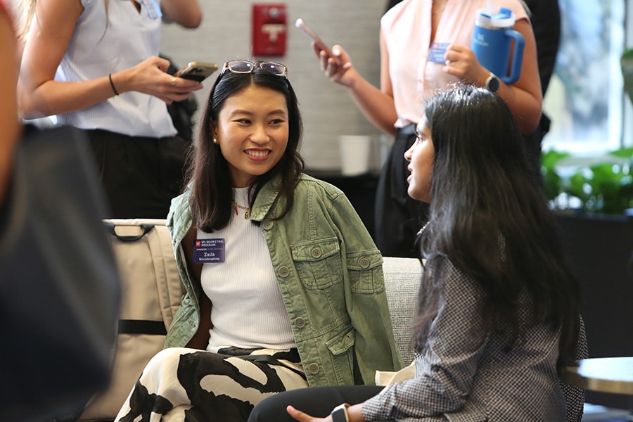 Graduate students sitting together at a networking event.