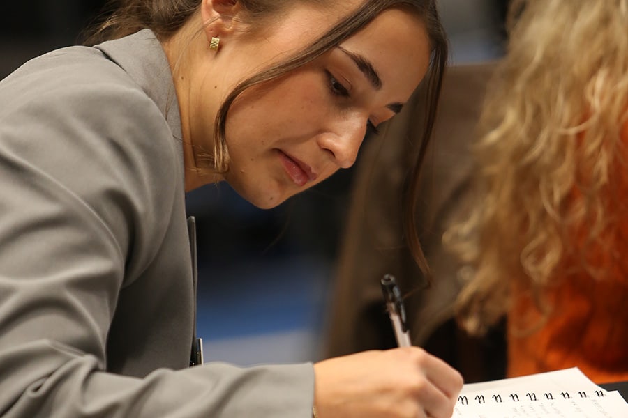 Closeup of student writing in a notebook.