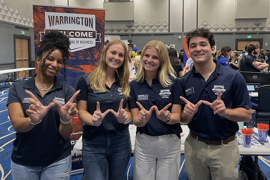 Group of students at a Warrington Welcome event booth.