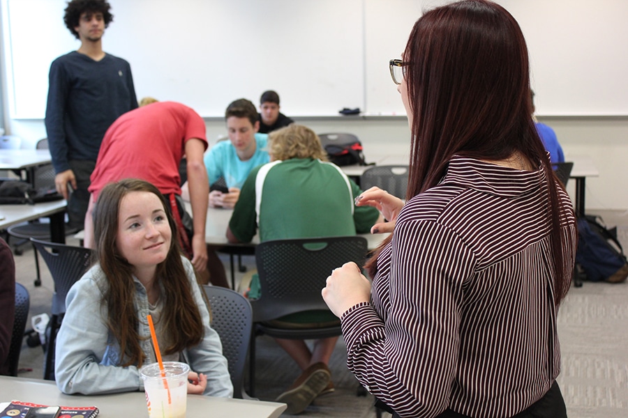 Students interacting in a classroom.