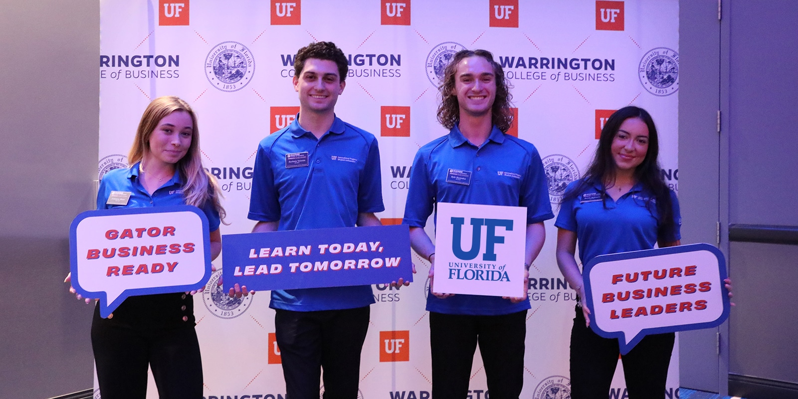 Students holding signs at the Warrington Welcome Professional Development Summit.