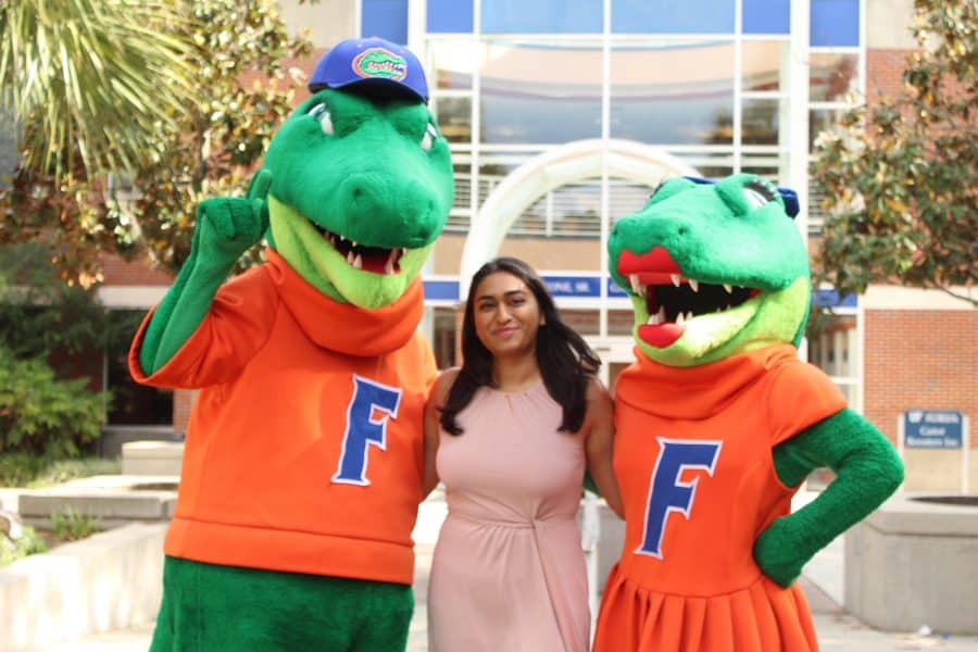 simrum waghray in front of ben griffin stadium with mascots albert and alberta