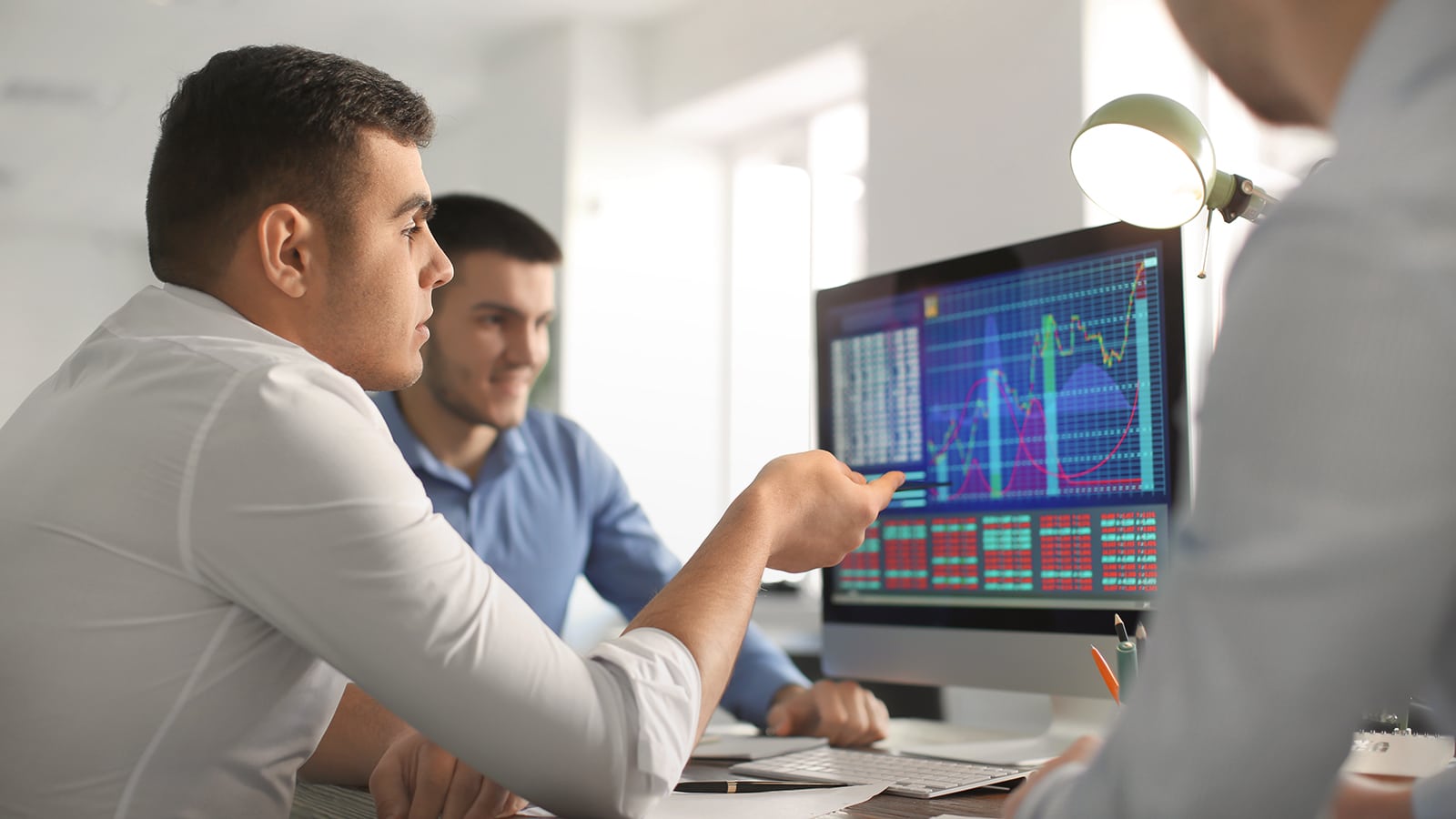 Young men working in office