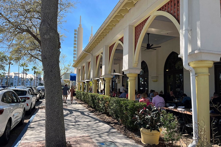A sidewalk along a covered, outdoor eating space in Celebration, Florida.