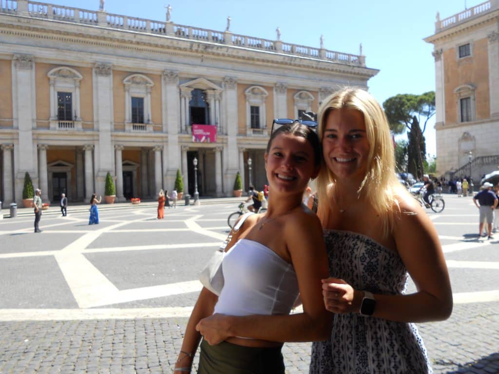 isabella eaton and friend in front of building in rome