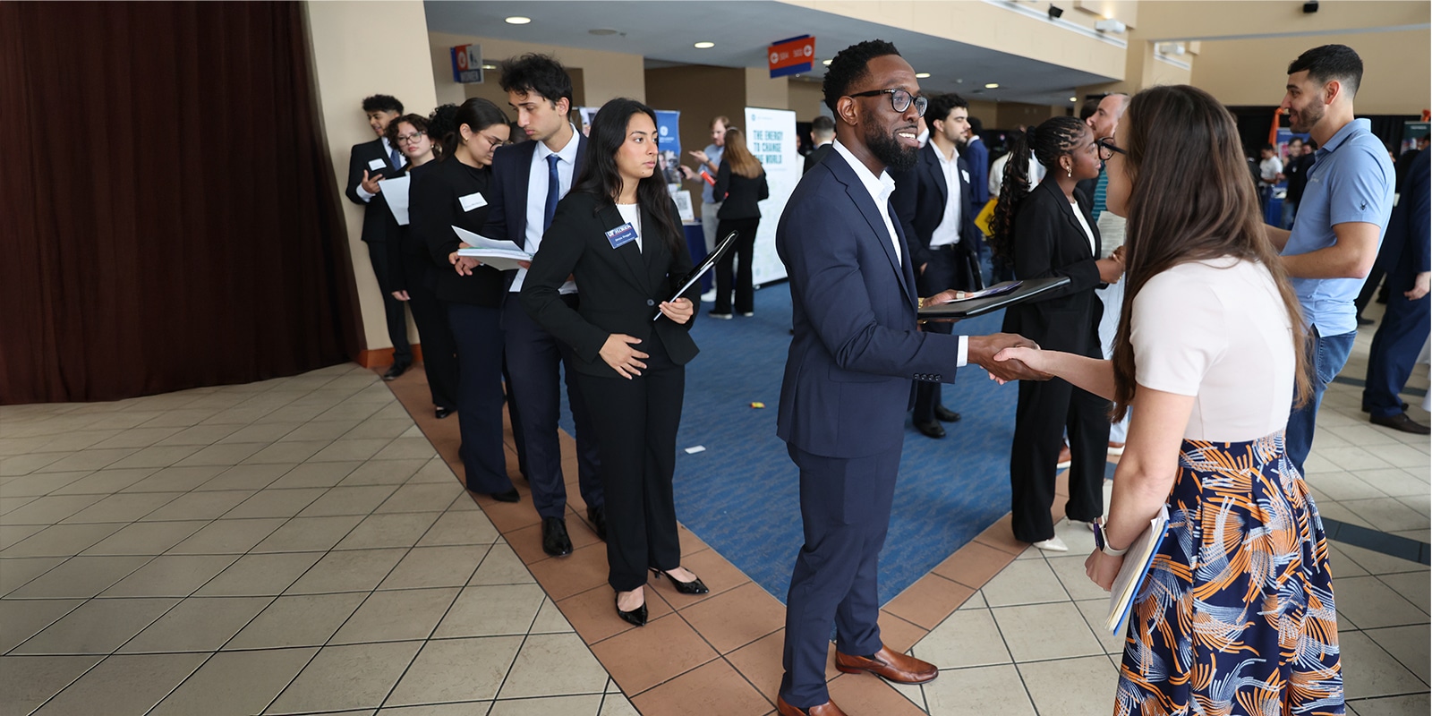 Student shaking hands with a recruiter at the Warrington Career Expo.