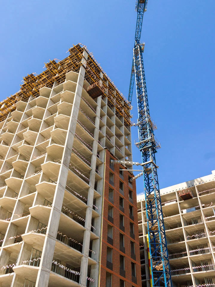 A new apartment being built with a crane next to it