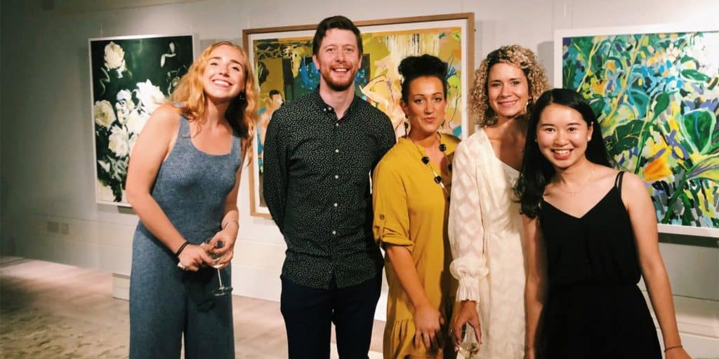 An internship student poses with her supervisor and colleagues