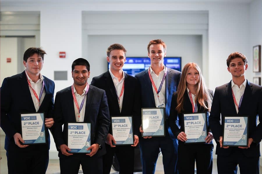 vcic capital venture competition winners smiling holding a plaque that says "2nd place"