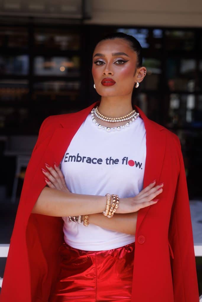 Aanya Patel poses in red wearing branded clothing for the Global Girls Initiative.