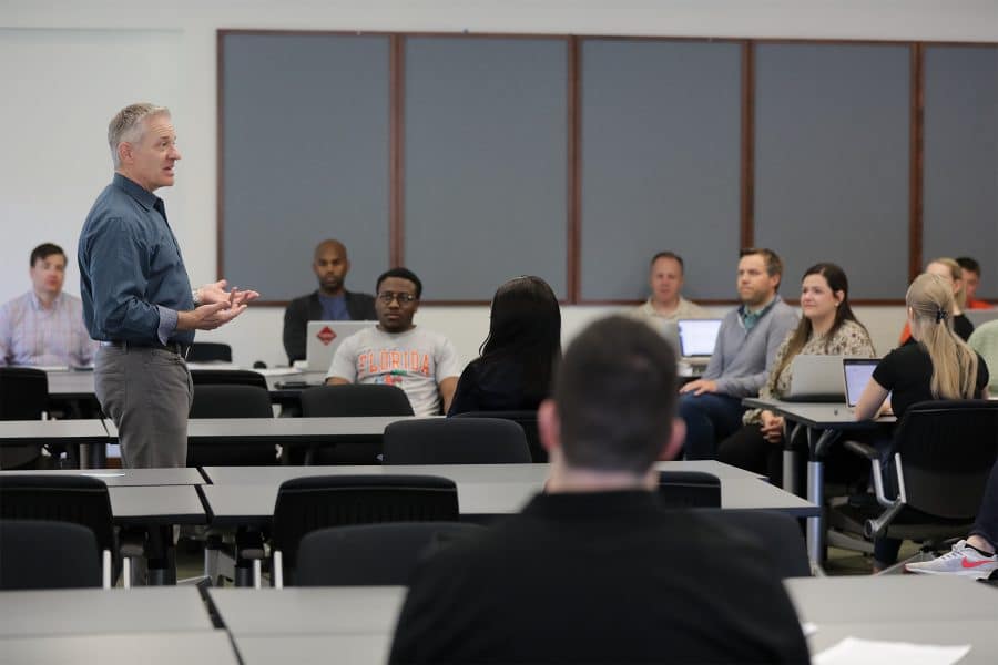 Professor teaches a class of students.