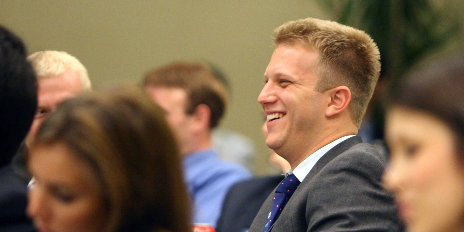 ISOM member smiling while attending an event.