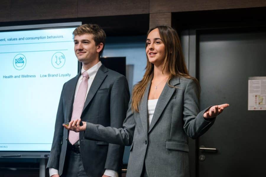 two students on the UF HICC team presenting in front of a screen