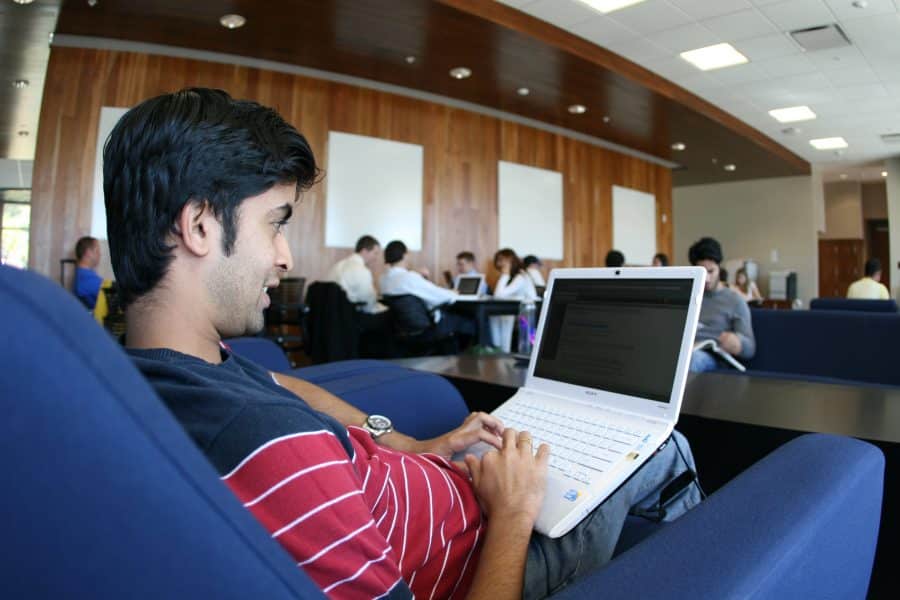 student working on a laptop in heavener