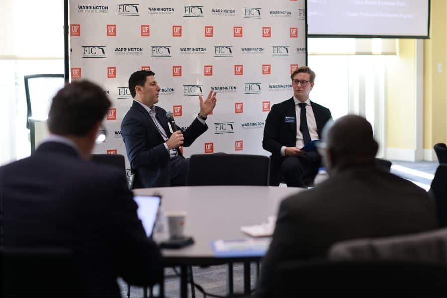 UF student Watson Hewitt moderates a panel with Jon Korngold (head of Blackstone Growth) at the Florida Investment Conference.