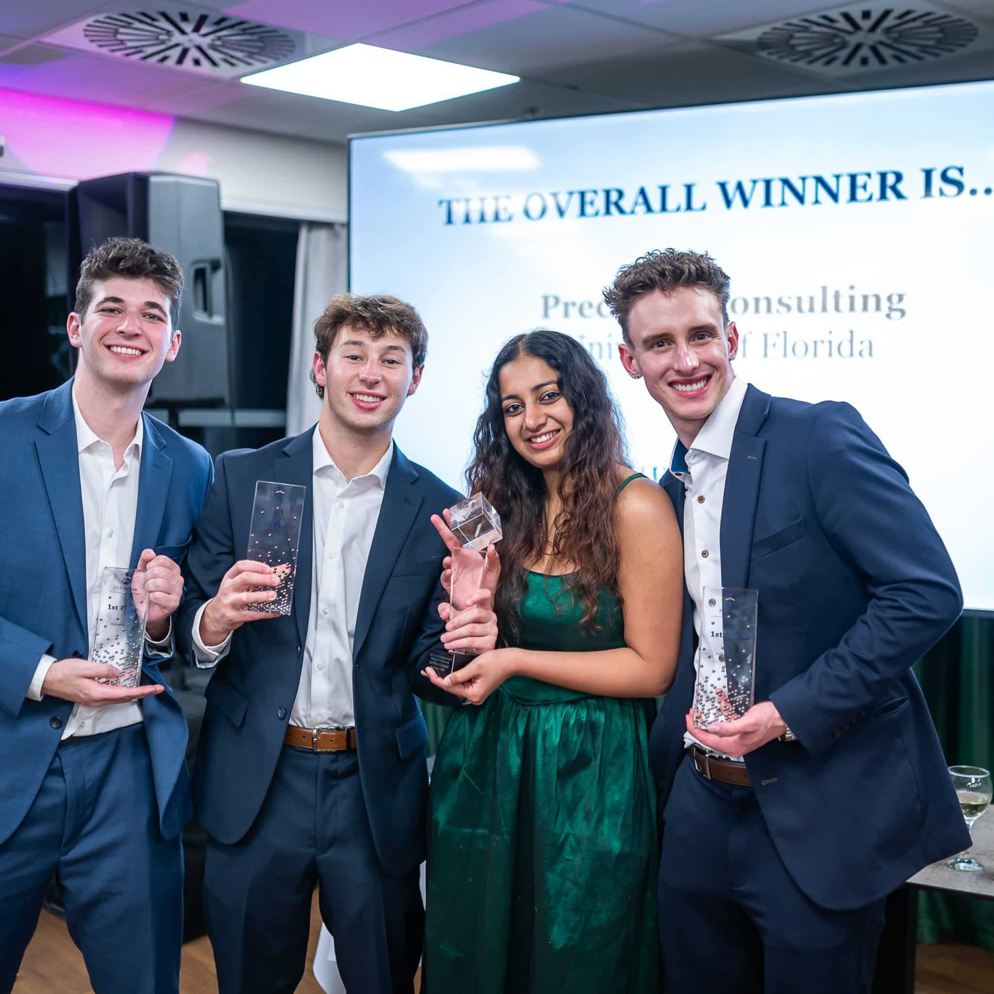 Members of the UF HICC team, Meghana Reddy. Zach DeKoven, Jacob Schneider, and Elias standing and smiling, holding trophies
