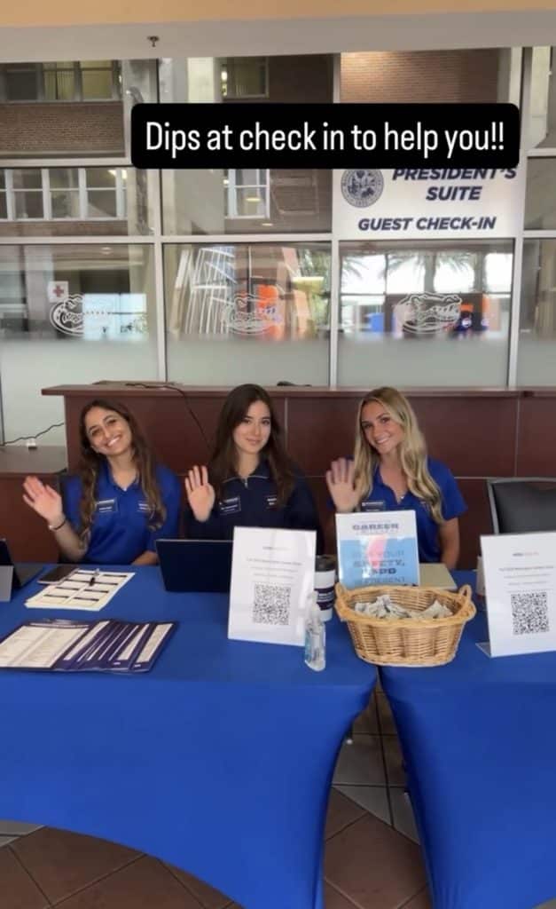 Alejandra sits with fellow Warrington Diplomats with the caption "Dips at check-in to help you"