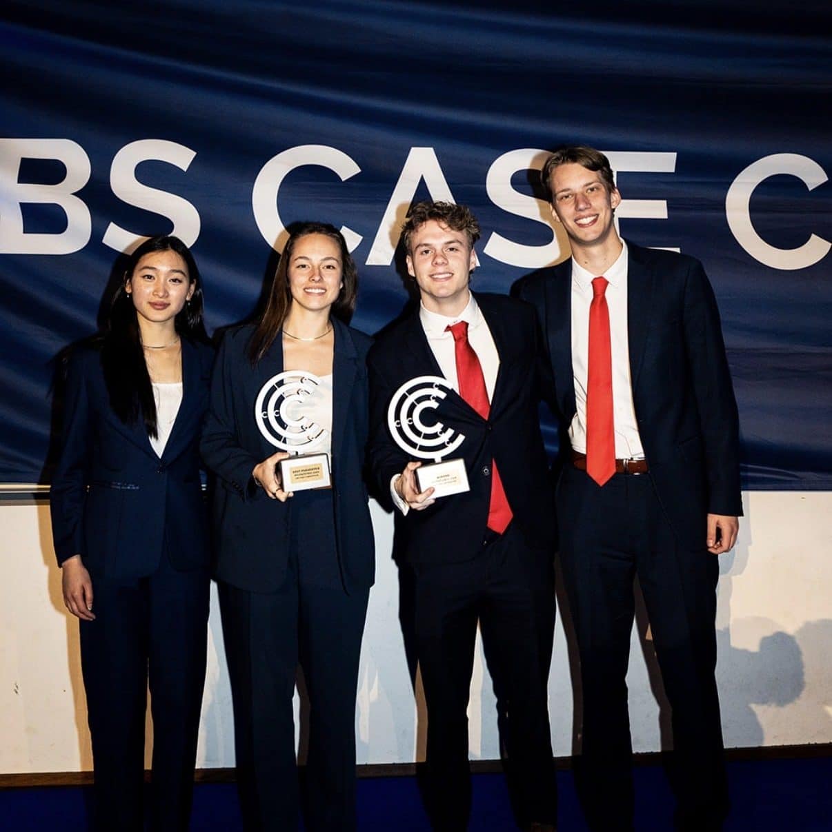 Members of the UF HICC team, Sarah Pagels, Zach Jones, Max Kochkin, and Vivian Phung standing, smiling, and holding trophies. 