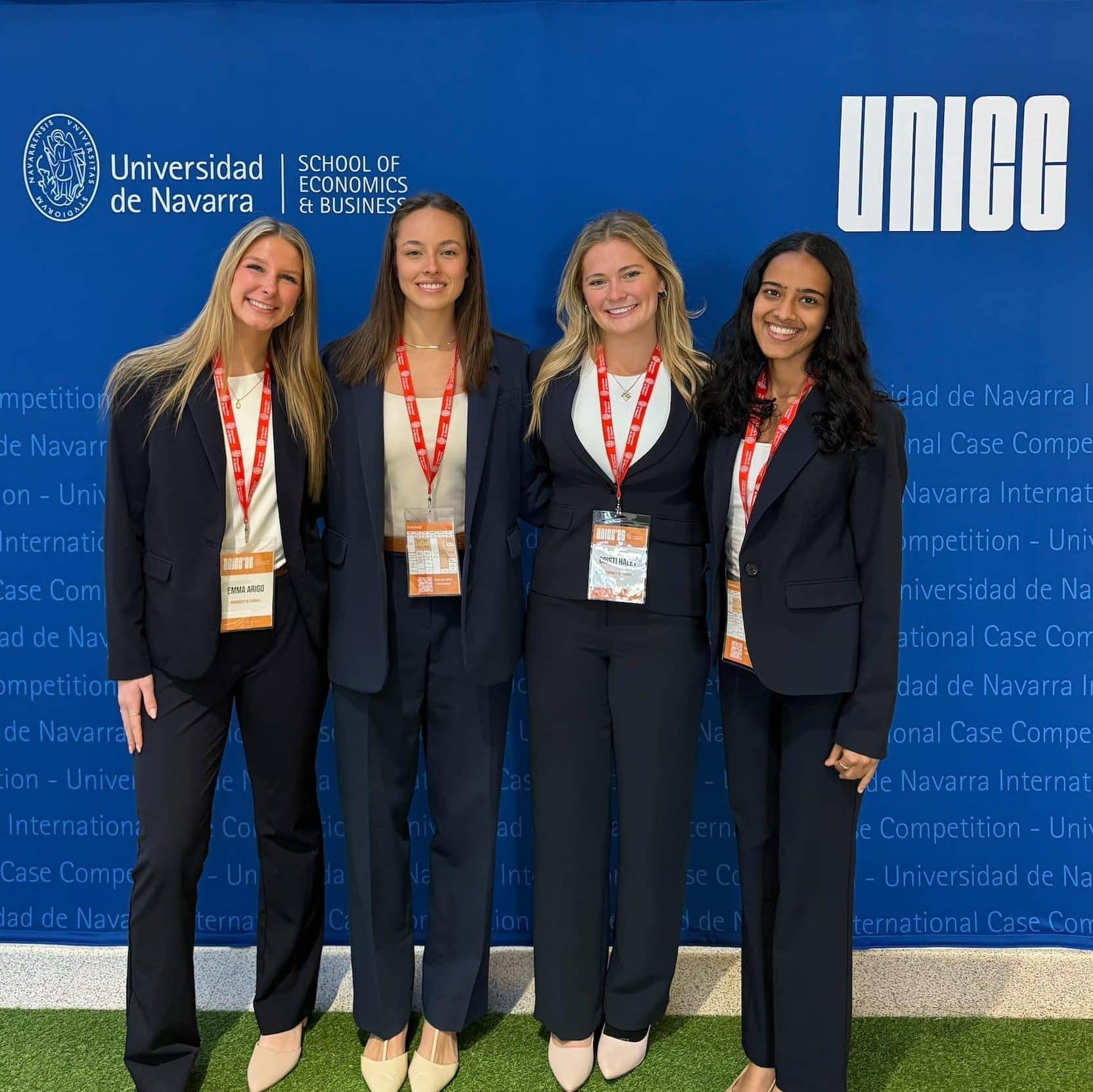 Members of the UF HICC team, Emma Arigo, Sarah Pagels, Cristi Haley and Sahana Vijay Krishna standing adn smiling in front of Universidad de Navarra sign