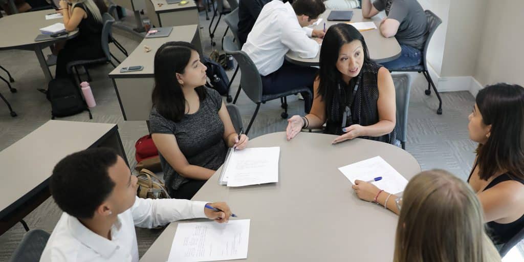 Group of students working at a table together.