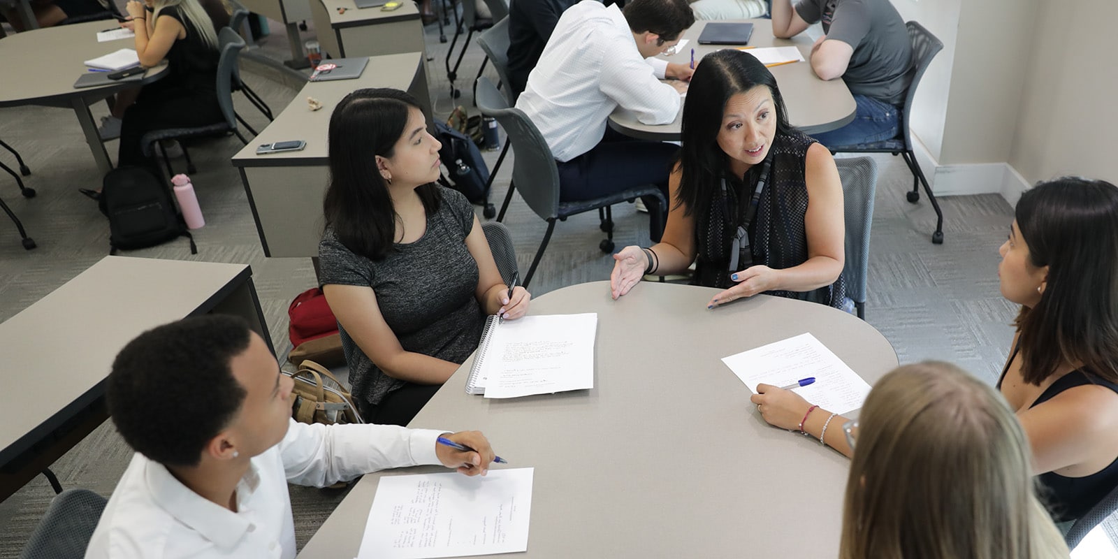 Group of students working at a table together.