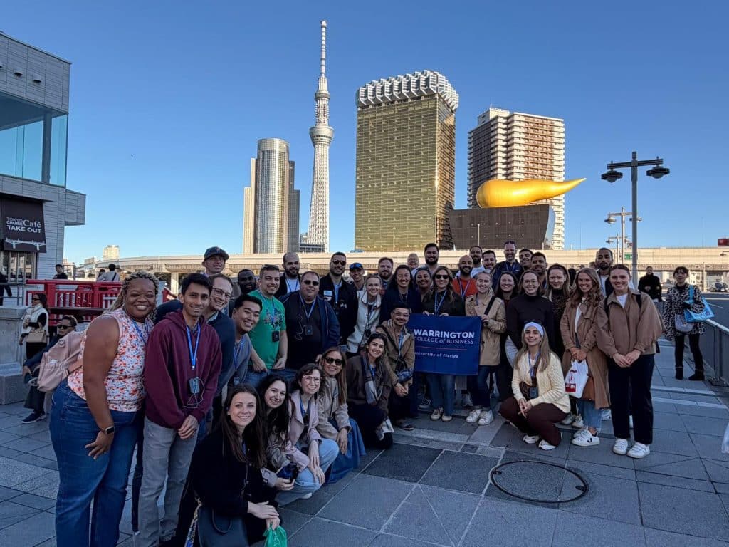 MBA student team in Tokyo holding the Warrington sign