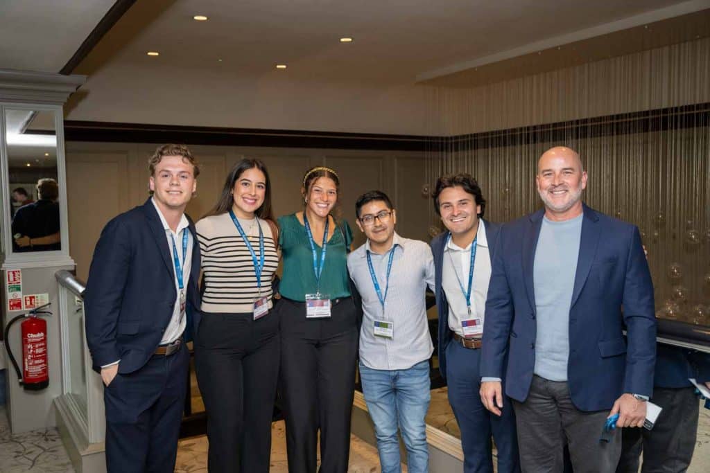 university of glasgow student team with their arms around each other smiling with sean limon