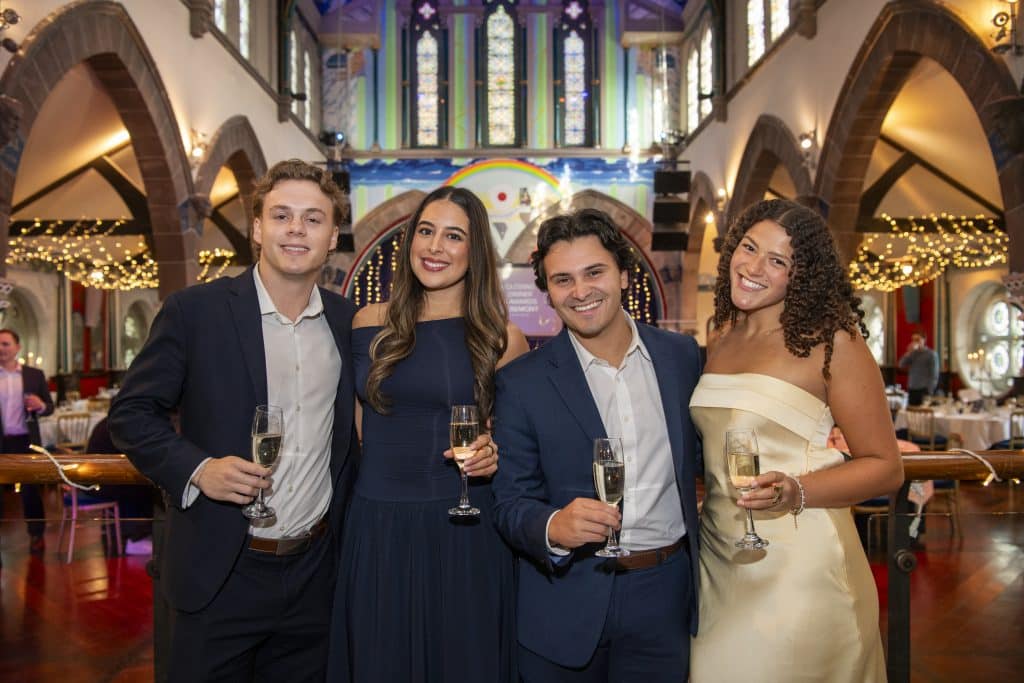 university of glasgow mib student team smiling and holding champagne