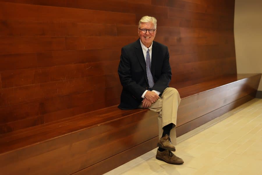 Gary McGill sits on a wooden bench