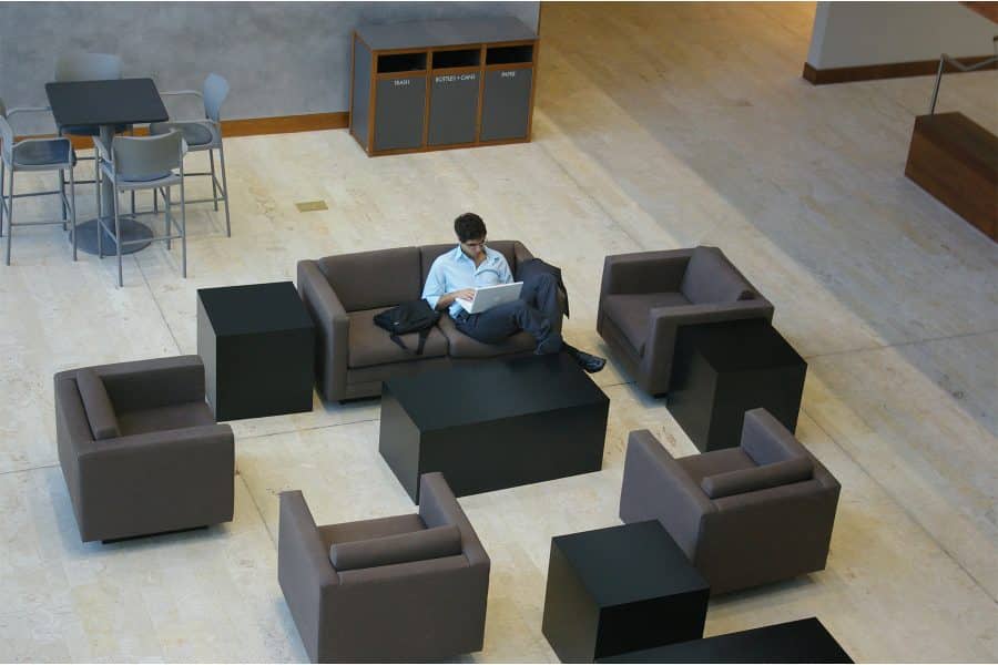 Man sitting in chair working on laptop