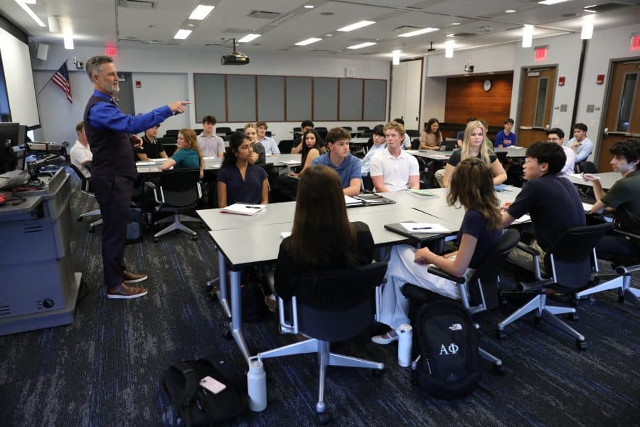 David Mascio stands at the front of a classroom of students teaching.