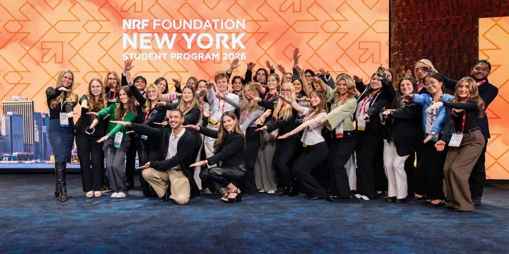 UF students in a group Gator Chomp with an NRF Foundation New York Student Program 2026 colorful background.