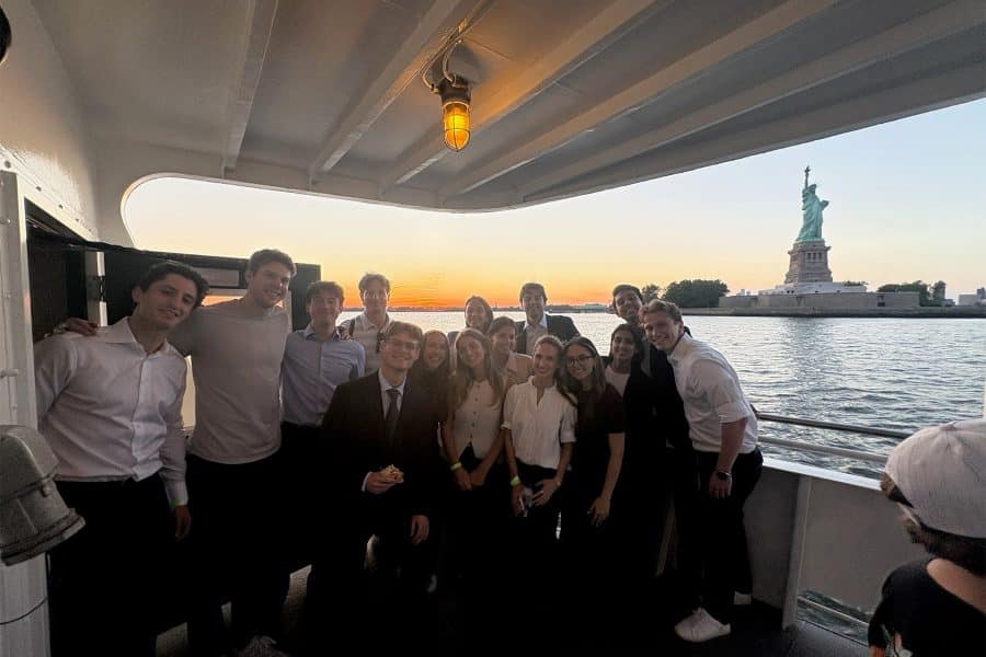 Warrington students on a boat in front of the Statue of Liberty.