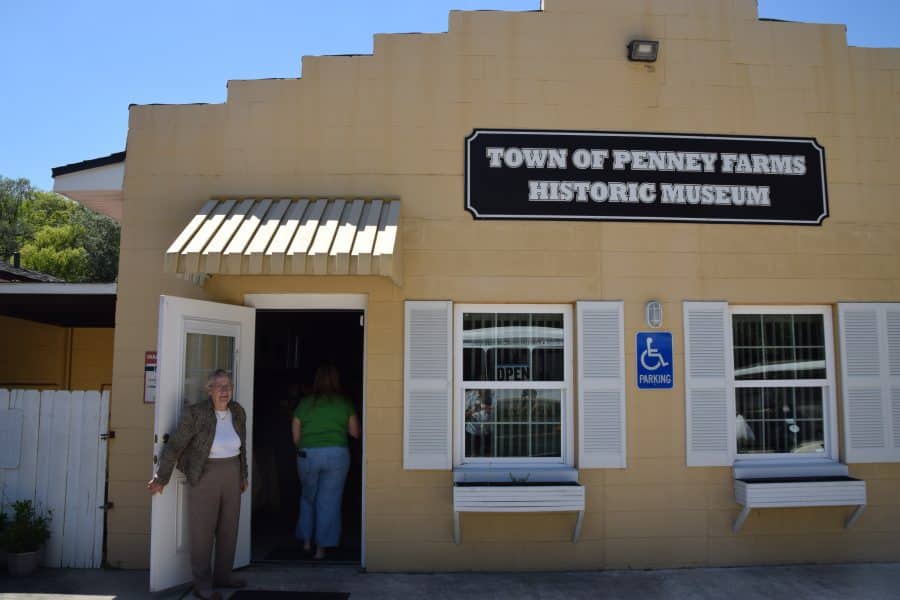 A woman stands in the doorway to the Town of Penney Farms Historic Museum.